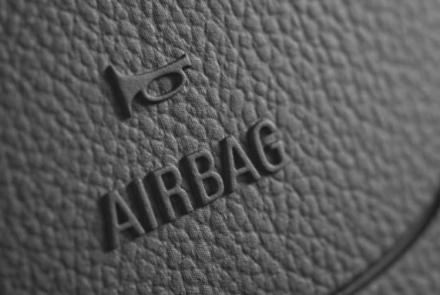 close-up image of steering-wheel with embossed "airbag" sign